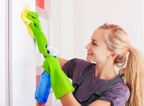 Professional office cleaner maintaining a Sutton workplace reception area