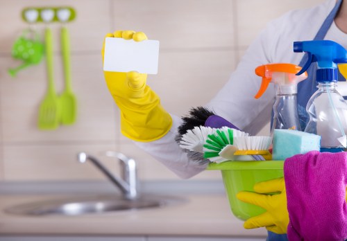 Oven cleaning operative preparing a safe kitchen workspace